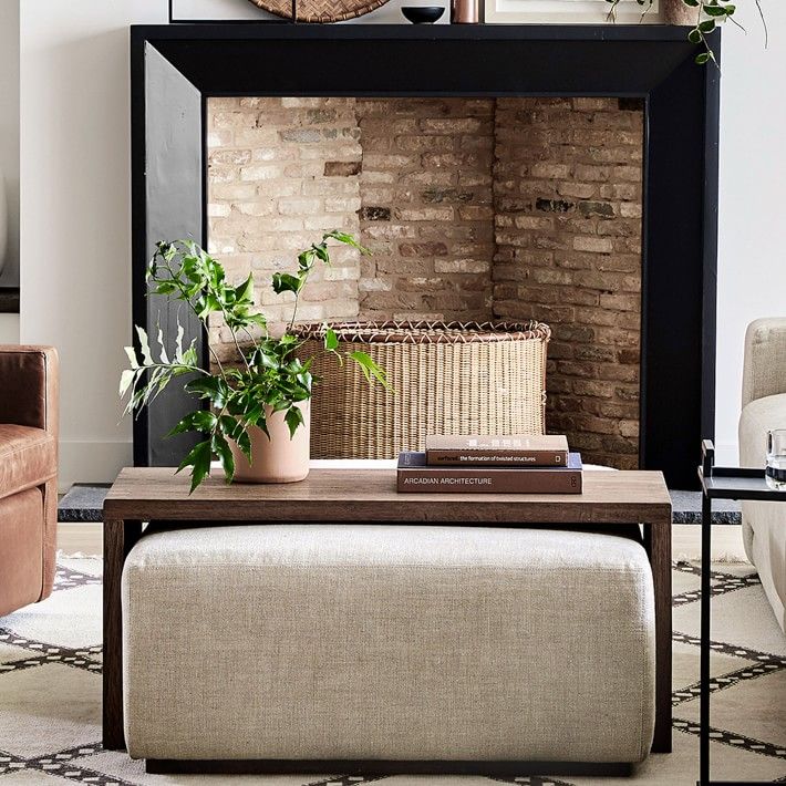 a living room filled with furniture and a large clock on the wall above it's fireplace