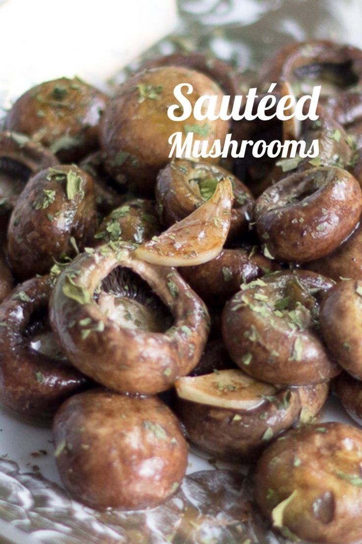 roasted mushrooms with herbs and seasoning on a glass plate in front of the words sauteed mushrooms