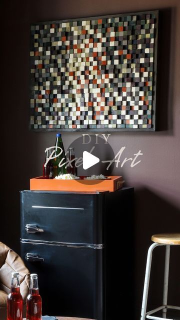 an old fashioned refrigerator in a living room next to a table with drinks on it