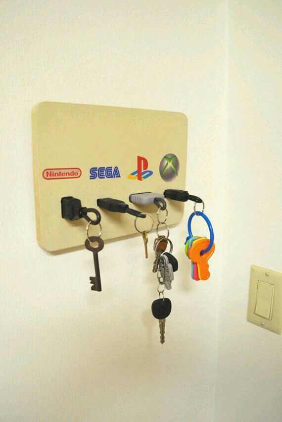 several keys are hanging on the wall with a key holder attached to it's side