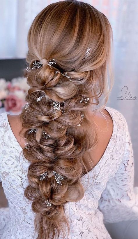 a woman with long hair in a half - up braid and some beads on her head