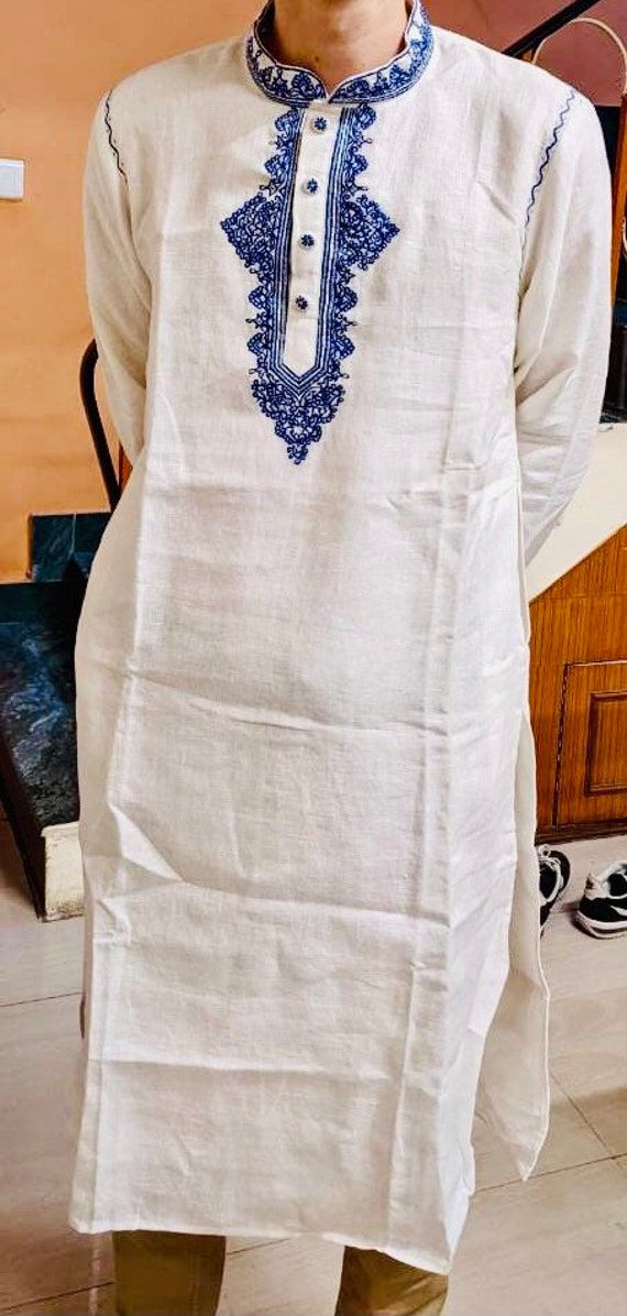 "Best Traditional Ethnic Linen Embroidered Kurta.  Made of 100% Pure Linen Solid Fabric.  DETAILS Fabric - 100% Pure Linen Straight Kurta With Full Sleeves. Color - White  Manual Machine Embroidery Size Chart S - Length 42''/ Chest 20''/ Sleeve Length 24 1/2''/ Bicep 9''/ Armhole 9 1/2''/ Shoulder 18\" M - Length 42''/ Chest 21''/ Sleeve Length 24 3/4''/ Bicep 9 1/4''/  Armhole 10''/ Shoulder 18 1/2'' L - Length 42''/ Chest 22''/ Sleeve Length 25''/ Bicep 9 1/2''/ Armhole 10 1/2''/ Shoulder 19'' XL - Length 42''/ Chest 23''/ Sleeve Length 25 1/4''/ Bicep 9 3/4''/ Armhole 11''/ Shoulder 19 1/2'' XXL - Length 42''/ Chest 24''/ Sleeve Length 25 1/2''/ Bicep 10''/ Armhole 11 1/2''/ Shoulder 20''   WASH CARE Gentle Hand Wash or Separate gentle machine wash.  PLEASE NOTE Please use the given siz Traditional Festive Kurta With Motif, Traditional Chikankari Embroidered Top For Eid, Traditional Linen Kurta With Resham Embroidery, Traditional Embroidered Straight Kurta Top For Eid, Eid Folk Style Kurta With Floral Embroidery, Folk Style Traditional Wear With Resham Embroidery For Eid, Traditional White Chikankari Embroidered Top, Eid Folk Style Traditional Wear With Resham Embroidery, Folk Style Cotton Kurta With Motifs