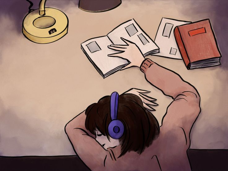 a person with headphones on reading books