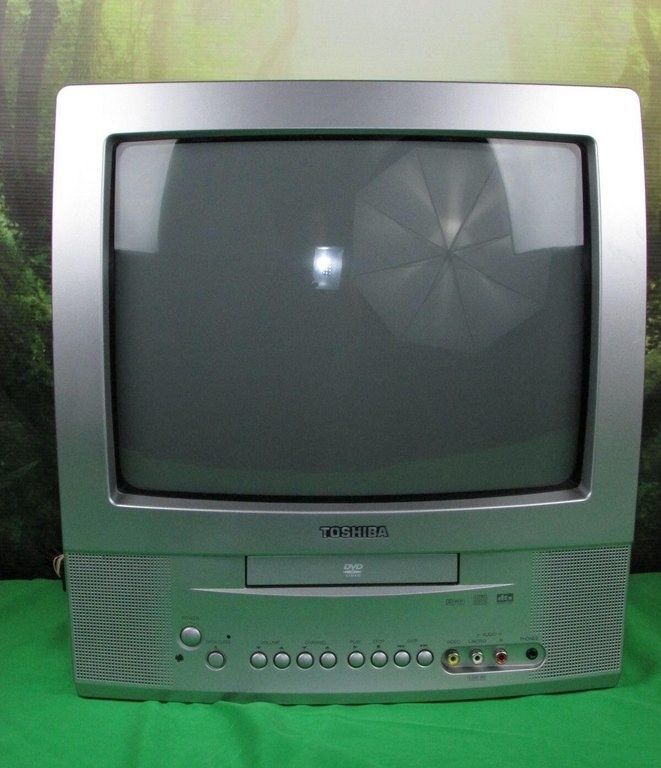 an old television sitting on top of a green table