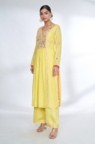 Yellow front gathered kurta with mirror embroidered yoke and sleeves with potli borders. Comes with coordinating palazzo. - Aza Fashions Bohemian Kurta With Gota Work For Navratri, Bohemian Gota Work Kurta For Navratri, Bohemian Kurta With Gota Work And Long Sleeves, Bohemian Long Sleeve Kurta With Gota Work, Bohemian Yellow Anarkali Set With Resham Embroidery, Bohemian Wedding Kurta With Dori Work, Yellow Long Sleeve Dress With Mirror Work, Long Sleeve Traditional Wear With Dori Work For Navratri, Bohemian Anarkali Set With Dori Work