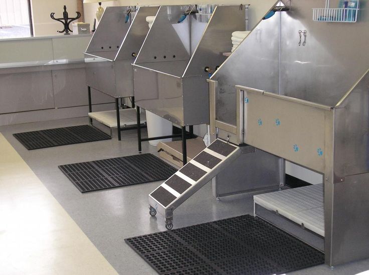 several stainless steel sinks in a large room