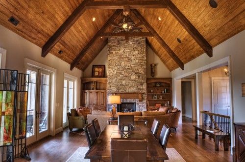 a large living room with wood floors and vaulted ceiling