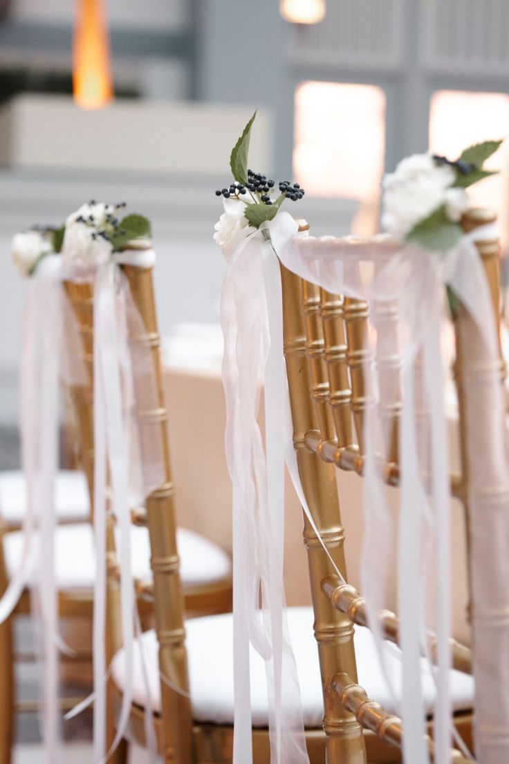 the chairs are decorated with ribbons and flowers