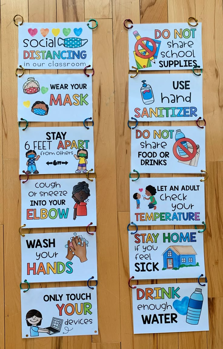 several signs are hanging on the wall in front of a wooden floor that says do not touch your hands