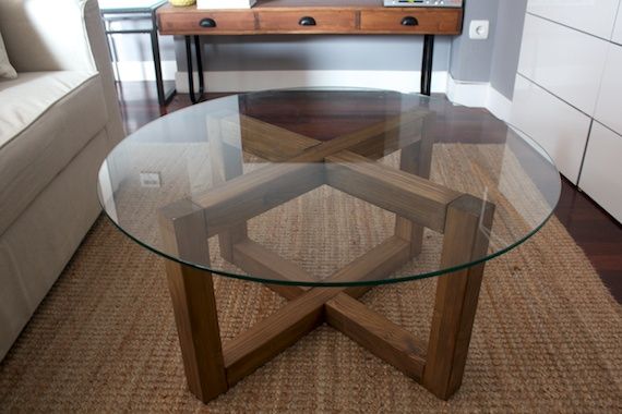 a glass table sitting on top of a wooden floor