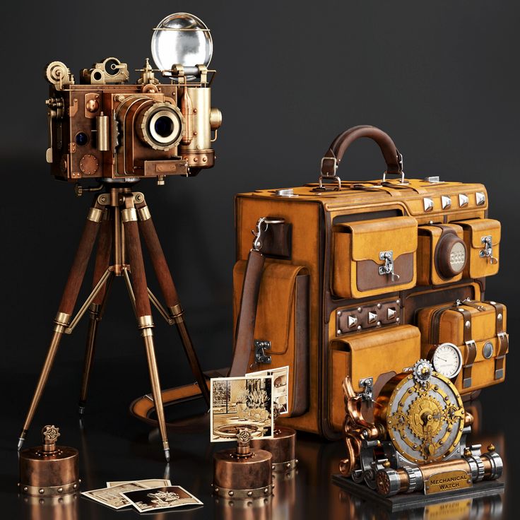 an old fashioned camera sitting next to some suitcases and a tripod on a table