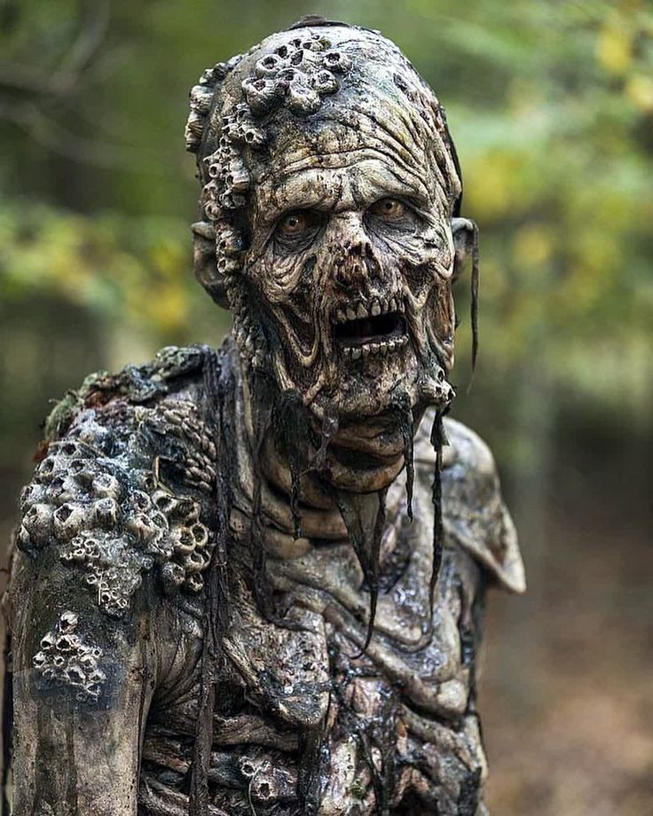 the walking dead character is covered in mud