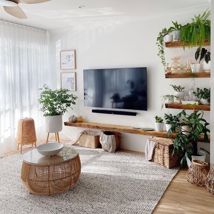 the living room is clean and ready to be used for tvs, plants, and other things