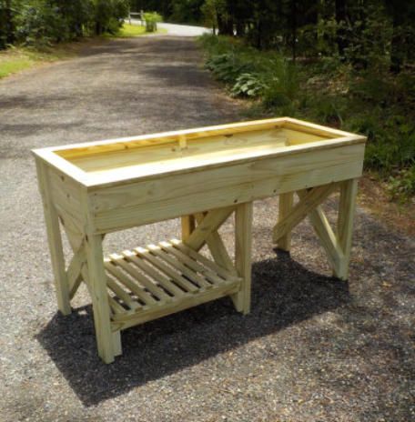 a wooden bench sitting on top of a gravel road