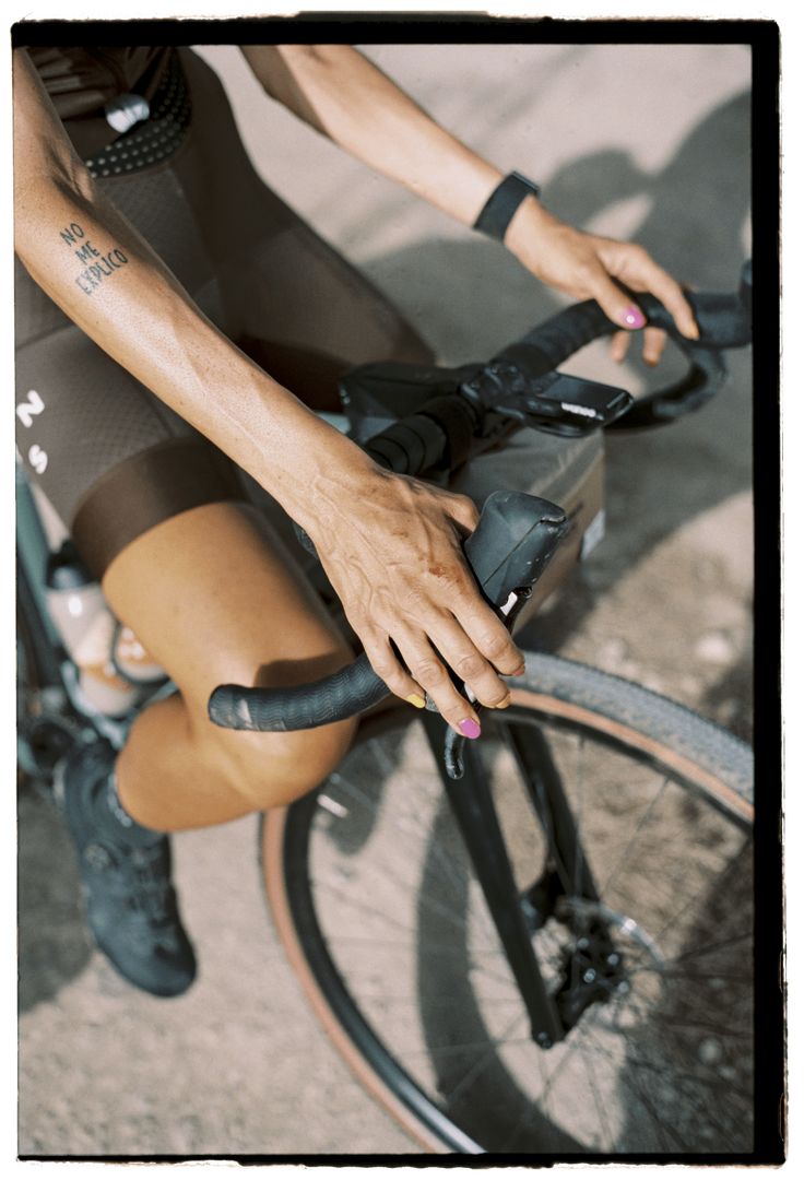 a close up of a person riding a bike with their hand on the handlebars