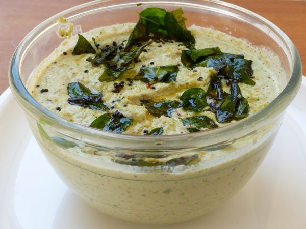 a glass bowl filled with food on top of a white plate