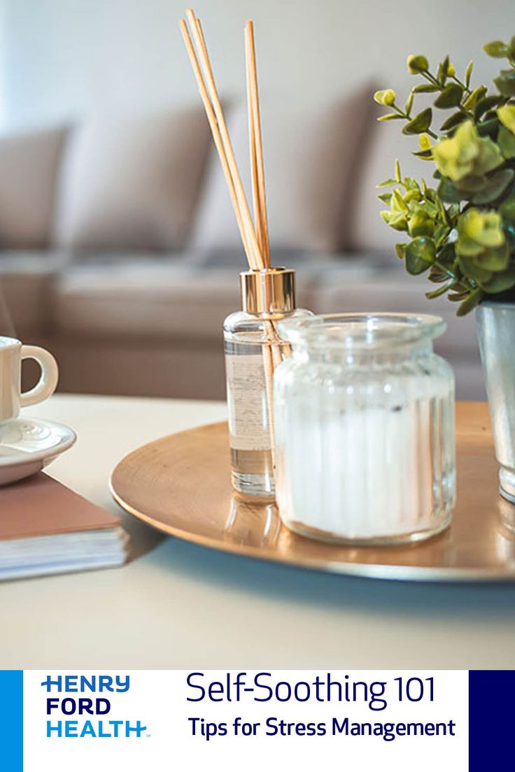 a table topped with a glass jar filled with liquid next to a cup and saucer