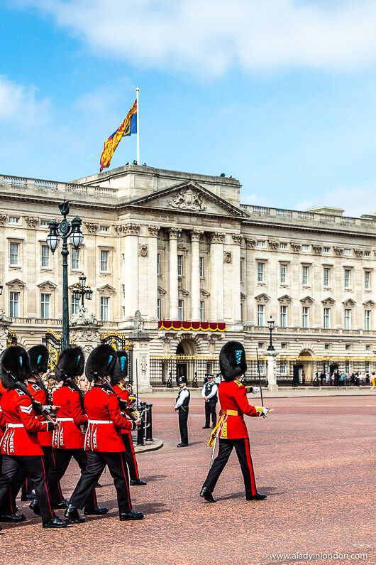 the guards are marching in front of buckingham palace