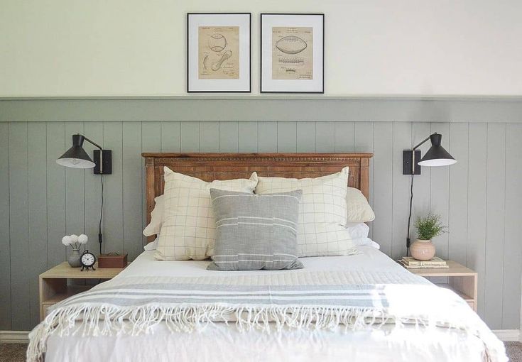 a bed with two lamps on either side of the headboard and pillows on each side