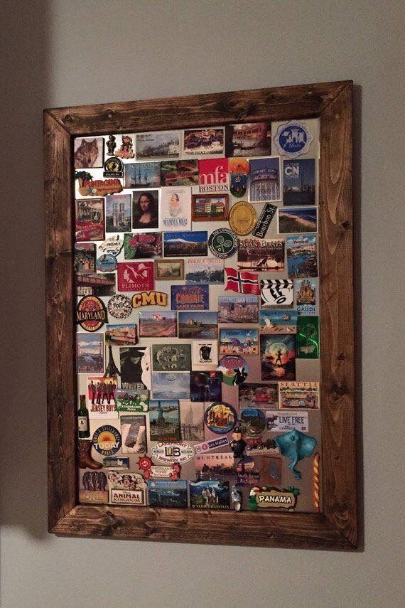 a wooden frame filled with lots of different types of stickers on the side of a wall