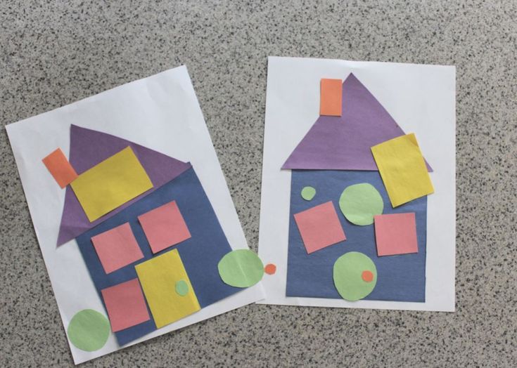 two pieces of paper cut out to look like houses