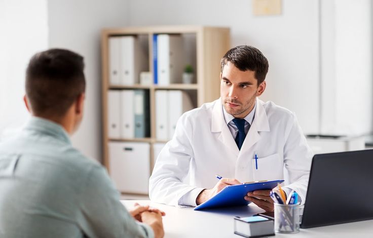 a doctor talking to a patient in his office