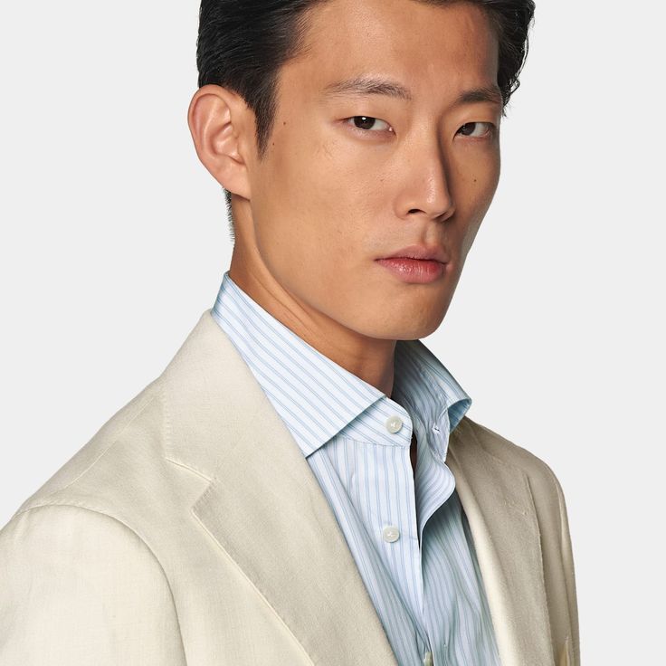 Cut to a relaxed fit, this off-white suit features a jacket with a natural shoulder and accompanying flat-front trousers with a straight-leg and belt loops. White Long Sleeve Suit With Single Button, White Business Suit With Suit Collar, White Classic Blazer With Concealed Placket, White Business Blazer With Concealed Placket, White Suits With Hidden Button Closure And Lapel Collar, Semi-formal White Blazer With Concealed Placket, White Blazer With Concealed Placket For Semi-formal Occasions, White Semi-formal Blazer With Concealed Placket, White Tailored Suit With Welt Pockets