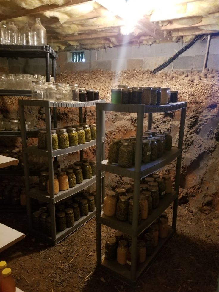 the shelves are full of jars and jars in the room with dirt on the floor