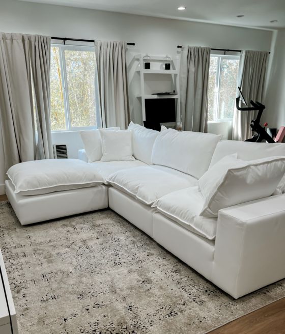 a large white sectional couch in a living room