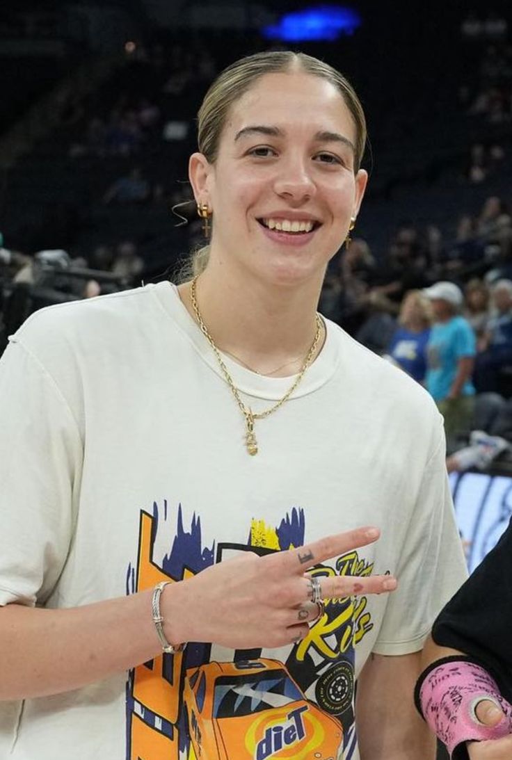 a woman standing in front of a basketball court