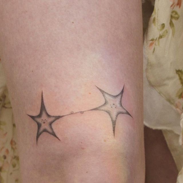 a woman's leg with two stars on it