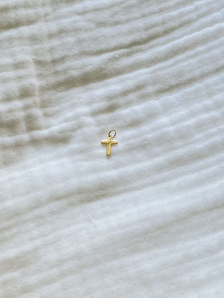 Introducing our newest addition: the Cross Charm! Made with gold-filled material, this charm adds a touch of elegance to any accessory. Perfect for showing off your faith (and fashion sense), the Cross Charm is a must-have for any jewelry collection. 14k Gold Filled Gold Charms For Everyday, Everyday 14k Gold Filled Gold Charms, Everyday 14k Gold-filled Gold Charms, Yellow Gold Charm Necklaces With Cross Pendant, Gold 14k Cross Pendant Charm Necklace, Dainty Gold Hypoallergenic Charms, 14k Gold Cross Pendant Charm Necklace, Dainty Hypoallergenic Gold Charms, Gold Cross Charm Necklaces