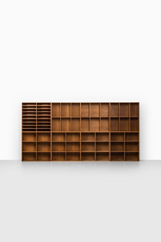 an empty bookcase is shown against a white wall