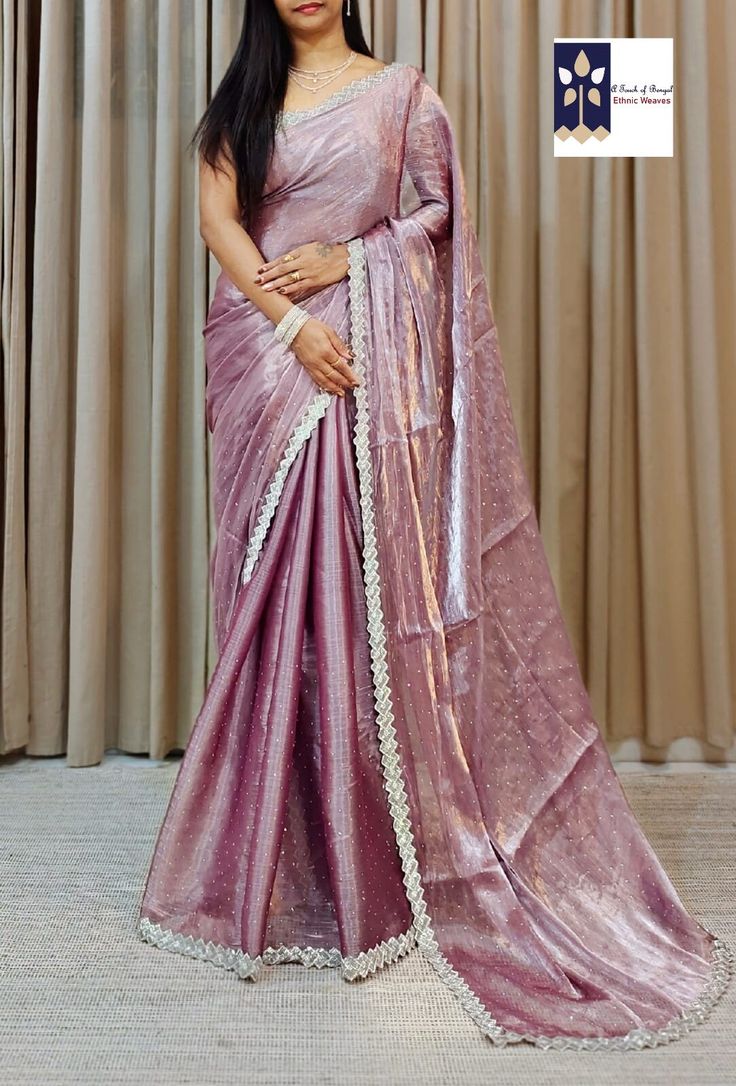 The enchanting allure of the Party Wear Embroidered Stone Embossed Cut Dana Work Jimmy Choo saree embodies elegance and sophistication. This exquisite attire embodies a perfect blend of traditional craftsmanship and contemporary aesthetics making it a standout choice for various celebratory occasions such as Diwali Durga Pooja, Bhai Duj, engagements or any festive party where one desires to dazzle and captivate. At the heart of this resplendent saree lies the fabric itself sourced from Jimmy Cho Purple Pre-draped Saree With Zari Work For Celebration, Eid Reception Zari Weaving Pre-draped Saree, Eid Celebration Pre-draped Saree, Eid Reception Blouse Piece With Zari Weaving, Eid Blouse Piece For Reception With Zari Weaving, Eid Blouse Piece With Zari Weaving For Reception, Elegant Purple Tissue Silk Pre-draped Saree, Elegant Purple Pre-draped Saree, Banarasi Silk Pre-draped Saree For Eid Reception