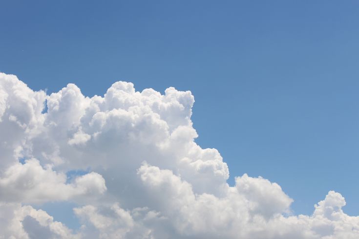 the plane is flying high in the blue sky with white clouds behind it and an airplane on the right side