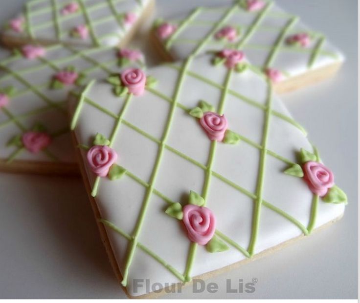 decorated cookies are arranged on a white table