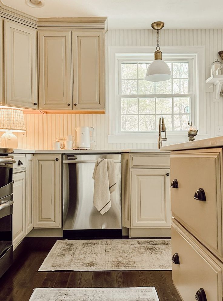 a kitchen with an oven, dishwasher and stove top oven in the corner