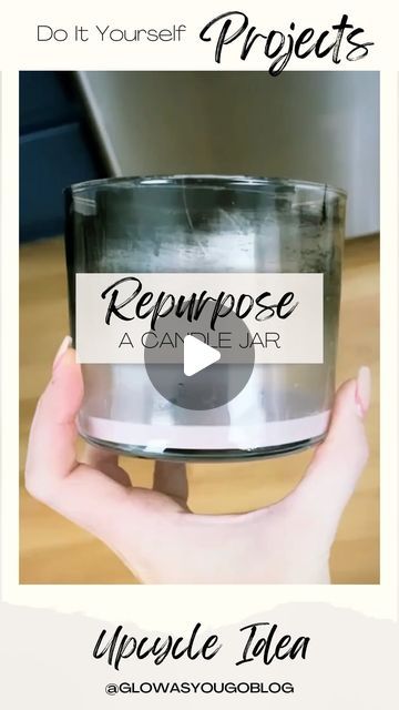 a person holding up a glass jar with the words repurpose in front of it