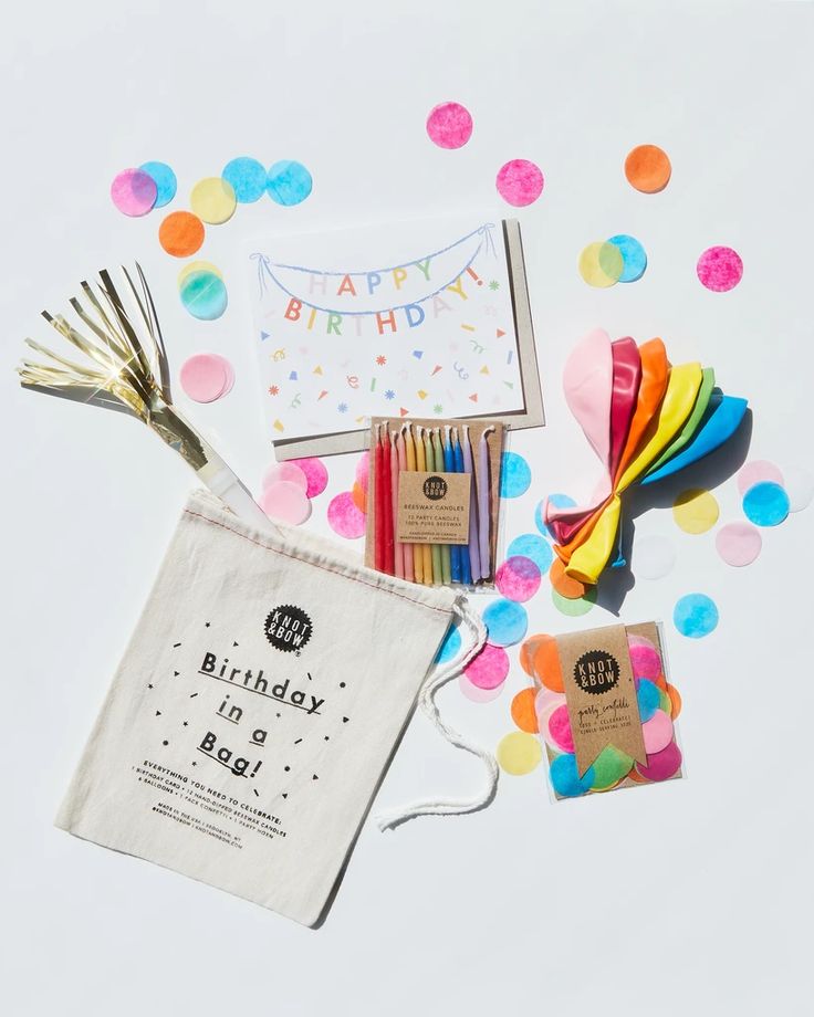 a birthday party bag with confetti, streamers, and other items on it