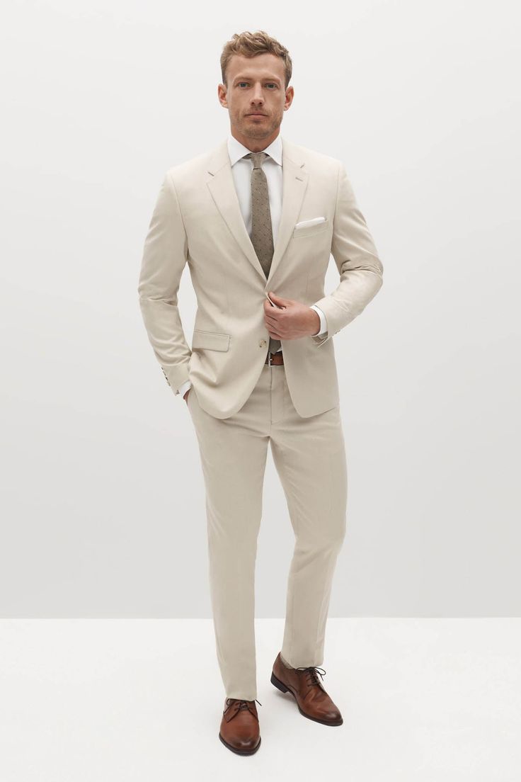 Fulfilled by our friends at SuitShopEmbody laid-back elegance in the light tan suit. This mod, sandy shade with visible woven texture throughout is designed to suit you from sunny celebrations to the office, candlelit dinners, and everywhere in between. The mens tan suit is crafted from signature Eco Stretch fabric, sure to keep you cool and comfortable through it all. Tan Groomsmen Suits, Tan Groomsmen, Tan Suits, Tan Suit Jacket, Suits Groom, Cream Suit, Grey Suit Jacket, Tan Suit, Beige Suits