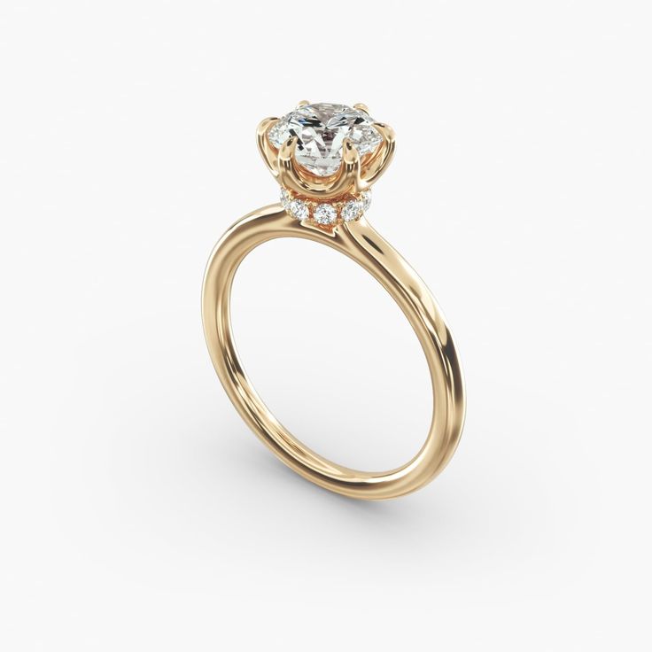 a yellow gold engagement ring with an oval cut diamond