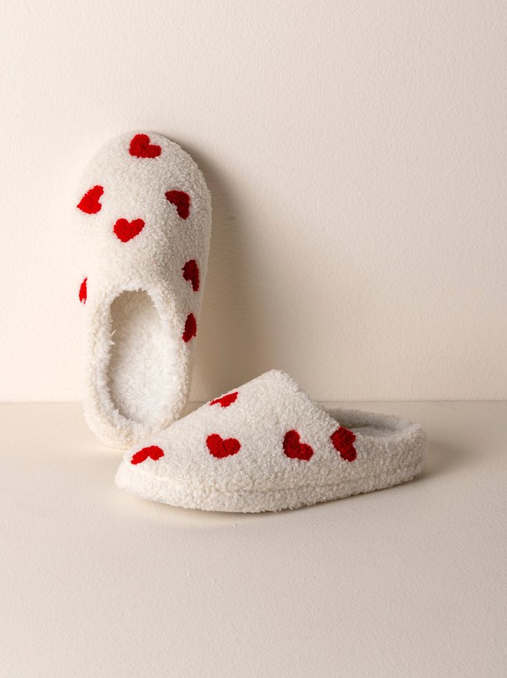 Your feet will thank you for kicking off your shoes and sliding into Shiraleah's Hearts Slippers. Closed toed and featuring a plush sherpa texture upon a rubber sole, these cozy house shoes are as sturdy as they are chic. The cute embroidered heart design adds a bit of playfulness to your new lounge wardrobe. Ribbon wrapped, this item makes a great gift option for yourself or others. Pair with other items from Shiraleah to complete the look! Color: Ivory S/M Fits Size 6-8, L/XL fits size 9-10 Po Slippers Aesthetic, Sherpa Texture, Vegan Packaging, Heart Slippers, Birthday 19, Christmas Slippers, Cozy Slippers, Cute Slippers, Ribbon Wrap