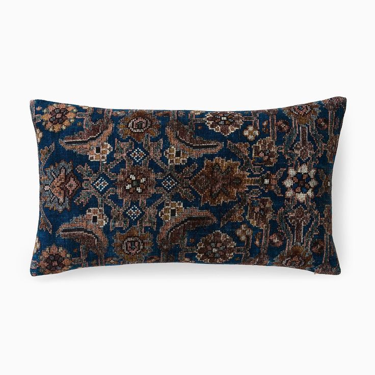 a blue and brown decorative pillow on a white background