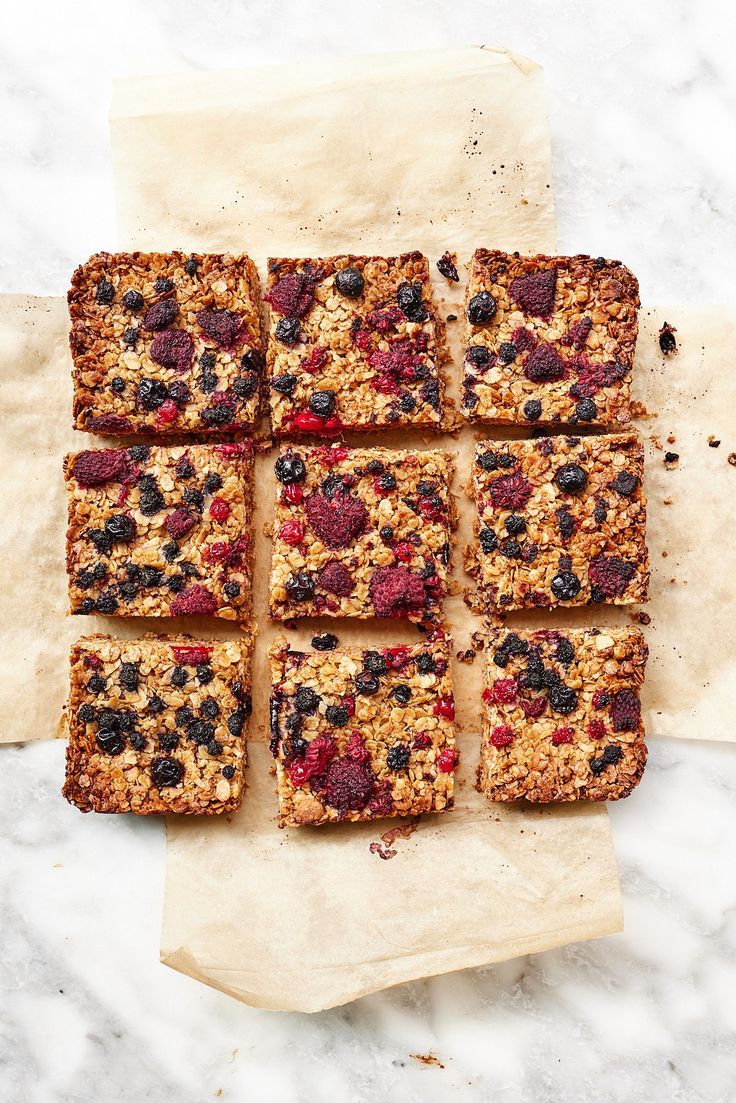 a bunch of granola bars sitting on top of parchment paper