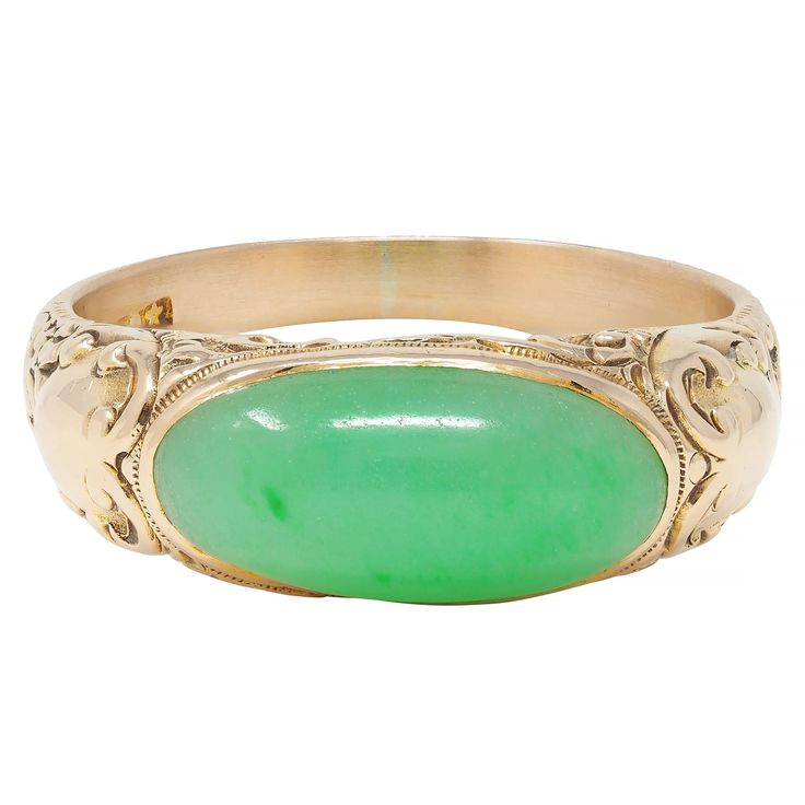 Centering an oval-shaped jade cabochon measuring 7.5 x 15.5 mm  Translucent pastel green with subtle mottling flush set east to west Flanked by engraved cartouche motif shoulders Featuring an engraved scroll motif surround  With high polish finish Stamped for 14 karat gold With maker's mark for Allsopp Bros. Circa: 1905 Ring Size: 9 1/4 and sizable Measures north to south 8.0 mm and sits 6.0 mm high Total Weight: 7.1 grams Stock Number: We-13152 Art Nouveau Ring, Art Deco Engagement, Gold Signet Ring, Bluish Green, Deco Engagement Ring, Art Deco Engagement Ring, Jade Stone, Gold Art, Pastel Green