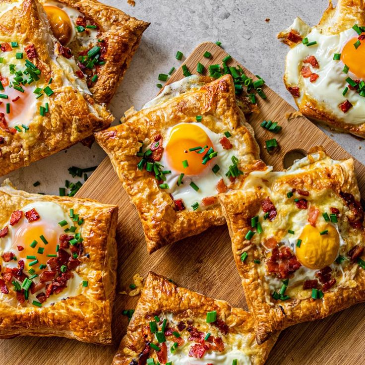 several square pieces of bread with eggs on them