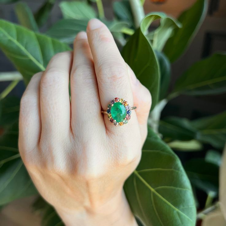 This Zambian emerald ring is set with multicolor sapphires and a willow branch band. Emeralds are known to have qualities of growth, reflection. love and peace. Willows are know for their ability to bend without breaking. Handmade in Los Angeles 14k yellow gold 3.3 carats Emerald Multi-stone Round Cut Ring, Multi-stone Round Cut Emerald Ring, Green Multi-stone Ruby Ring, Fine Jewelry, Round Multi-stone Emerald Ring, Round Cut Multi-stone Emerald Ring, Fine Jewelry Green Sapphire Multi-stone Ring, Multi-stone Emerald Diamond Ring For May Birthstone, Fine Jewelry Green Multi-stone Sapphire Ring, Green Multi-stone Emerald Ring Fine Jewelry