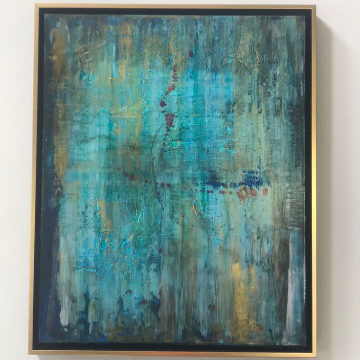 an abstract painting with blue and green colors on a white wall next to a black framed object