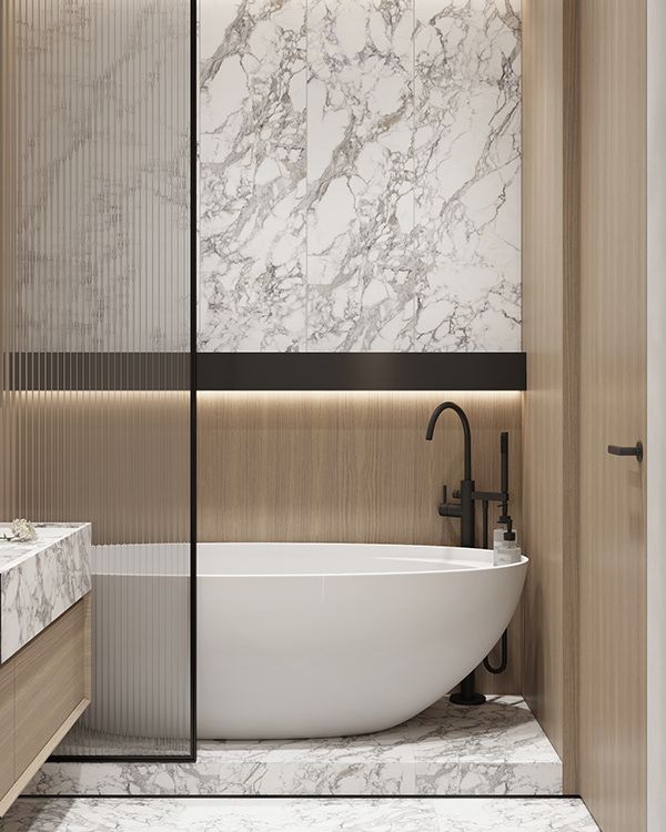 a bathroom with marble walls and flooring next to a bathtub in the corner