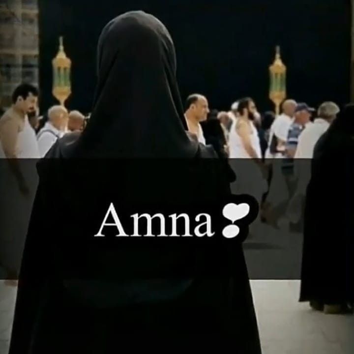 a woman in a black hijab is looking at people